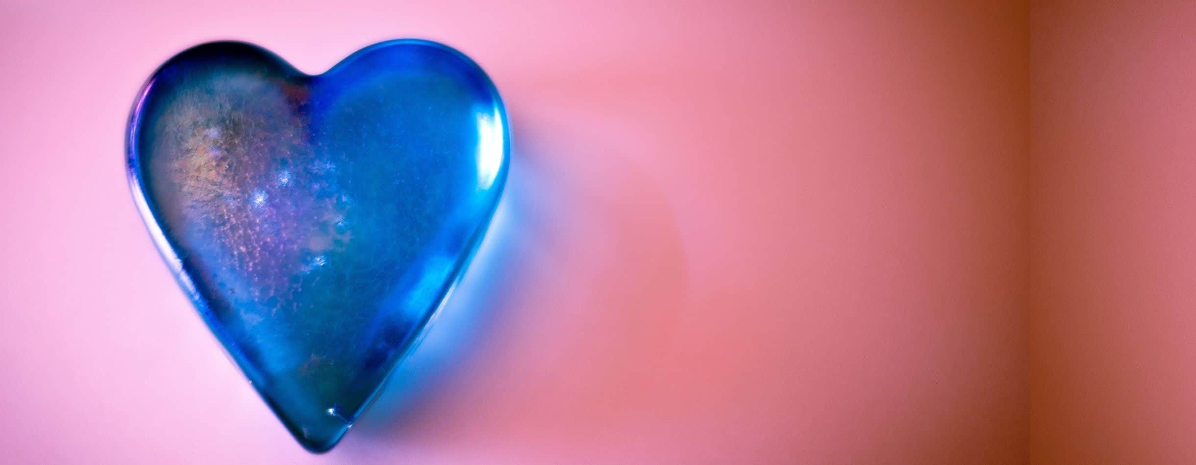 A blue heart lays on top of a red background