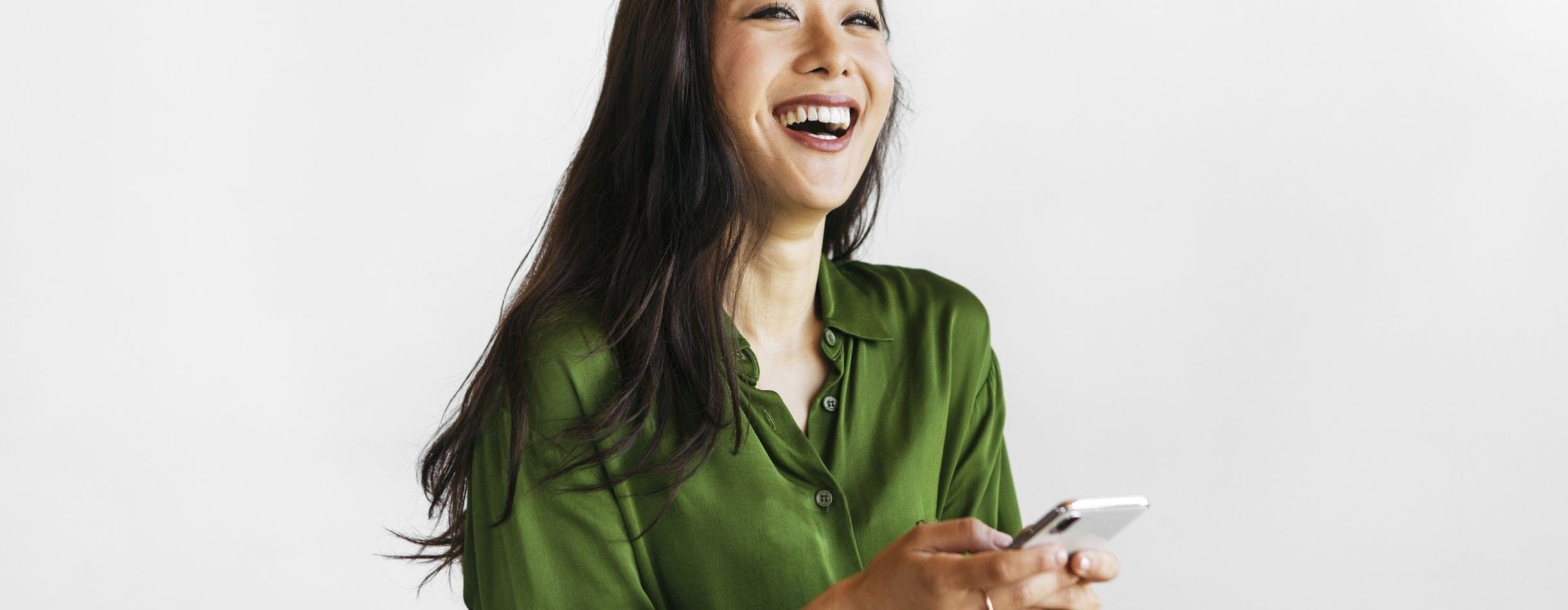 Woman holding her phone and smiling