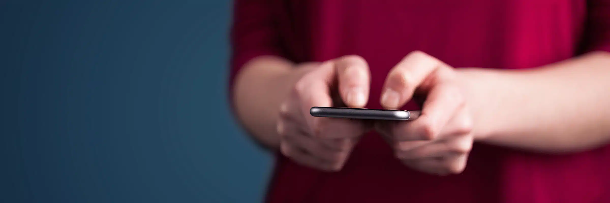 Someone using a smartphone to contribute to a text-to-give campaign