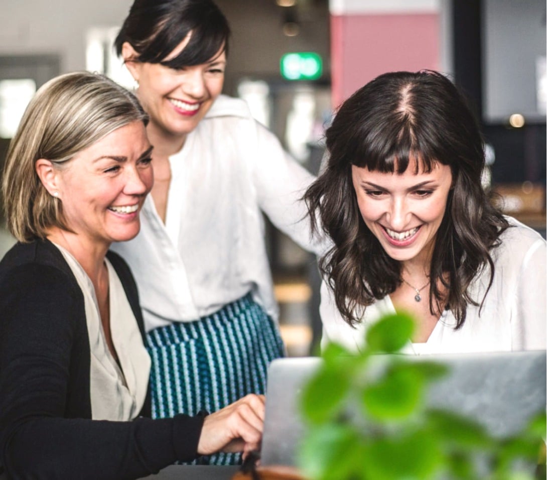 Three ladies at a laptop