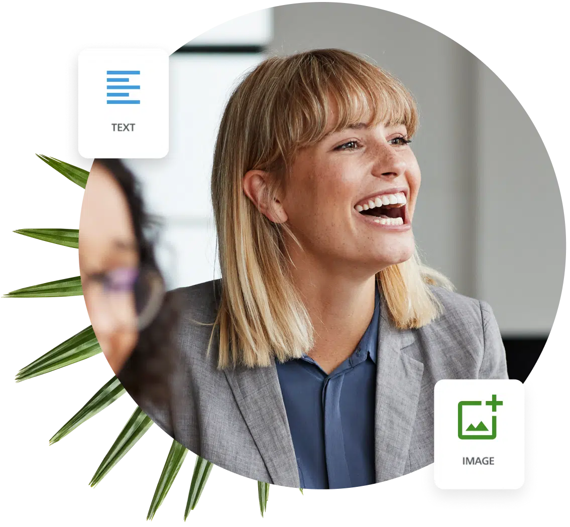 A woman wearing a grey blazer laughs with her coworkers after hearing a joke from a presentation on their organization's impact with their donors.