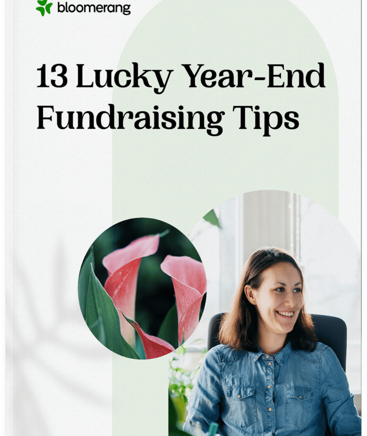 The cover for Bloomerang's ebook titled "13 Year End Fundraising Tips" is displayed with a woman and tulip flowers being shown.