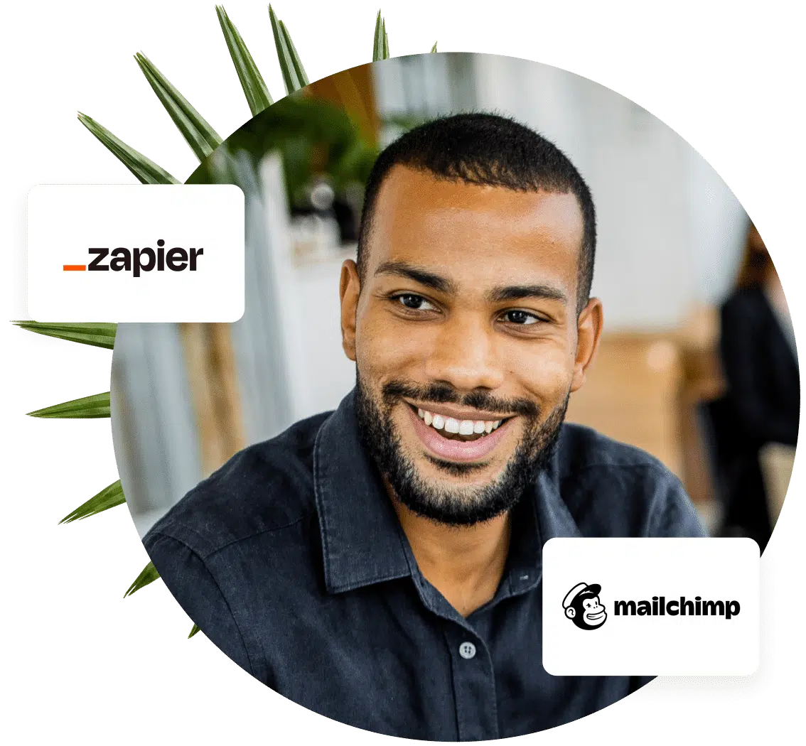 A man smiles while wearing a navy button down. Zapier and Mailchimp are two softwares that can integrate with Bloomerang records.