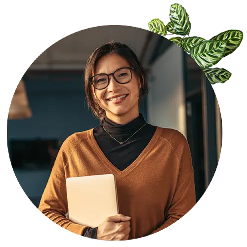 asian woman smiling and holding laptop