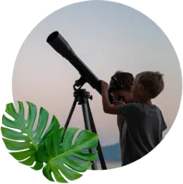 children looking at the night sky through a telescope