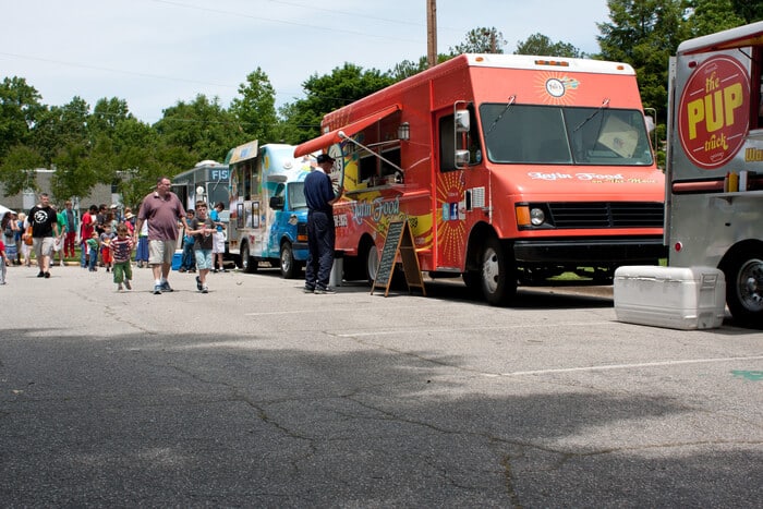This image shows food trucks at a festival, which is an area your festival volunteers can help manage. 
